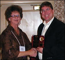 Chris Hopkins receives award on behalf of MHN